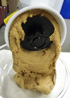 Peanut butter flowing out of the Wonder Junior hand grain mill